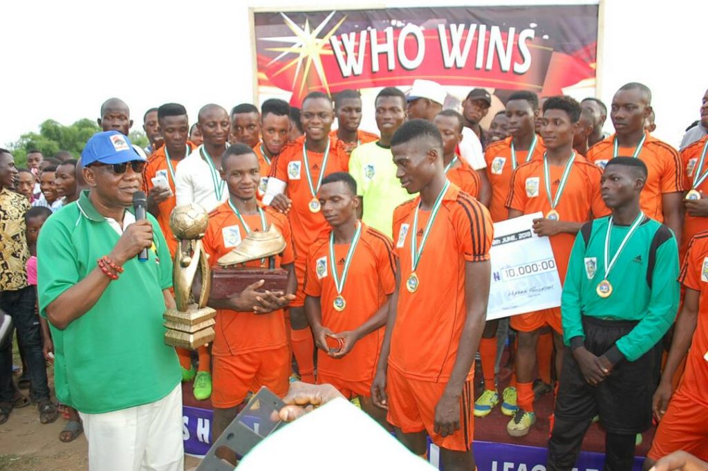 Jegun Adetimehin presenting the trophy to Ujamaa FC winners of the Township Football League Competition 2018.