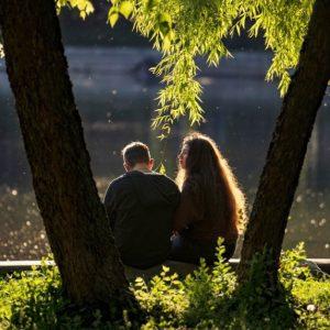 couple sitting in park lake pond 1 7055690 1727526233744