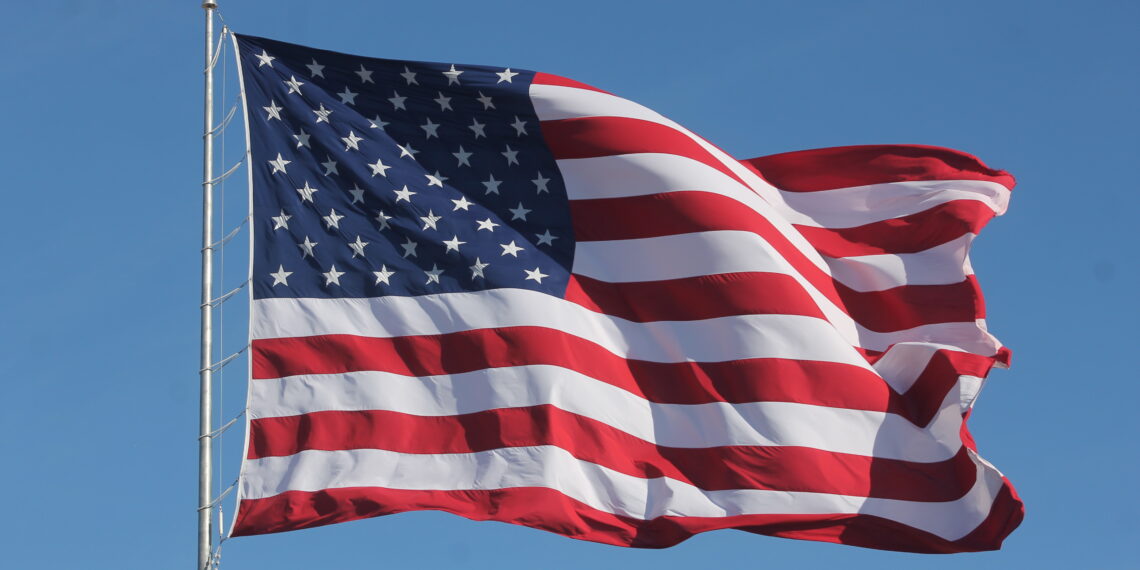 American Flag Waving on a Flag Pole 1140x570 1